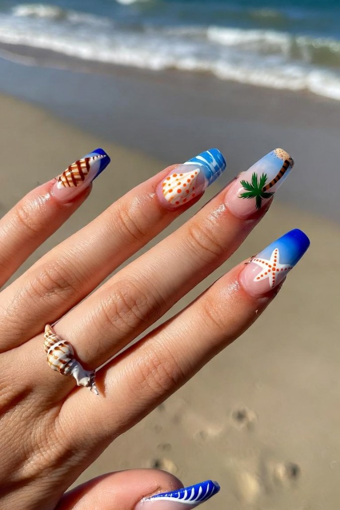Beach-themed acrylic nail art with palm trees, seashells and waves